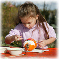 girl painting a pumpkin